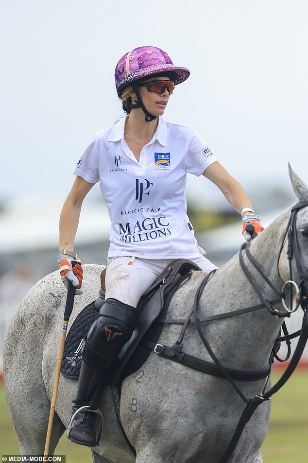 Meanwhile, his photographer wife, 43, kept a sturdy seat on her horse throughout the entire match as she rocked a bright pink helmet