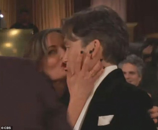 Just seconds after the win was revealed, the Irish actor's longtime wife Yvonne McGuinness grabbed his face and kissed him