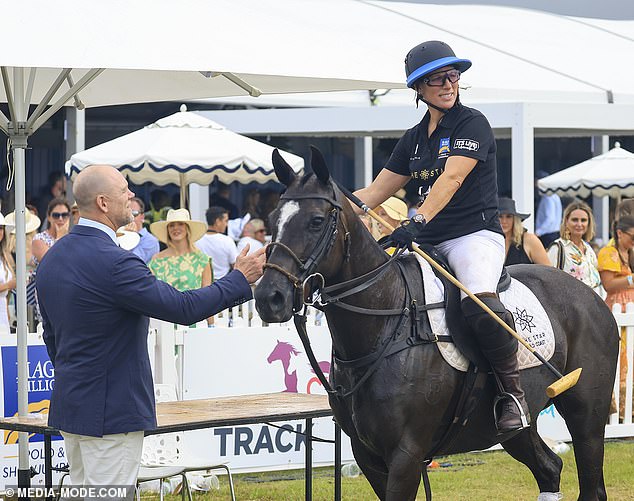 Mike gave his wife a smooch while she competed in a game of polo at the outing at Doug Jennings Park on the Gold Coast in Australia