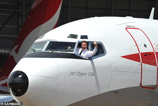 Hollywood superstar John Travolta waves from the cockpit window of his Boeing 707