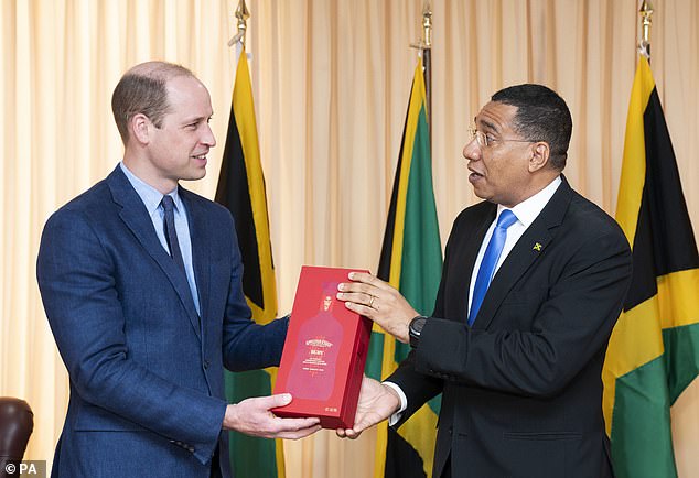 The Prime Minister of Jamaica, Andrew Holness presents the Duke of Cambridge with a bottle of Appleton Estate Ruby during a meeting at his office in Kingston, Jamaica