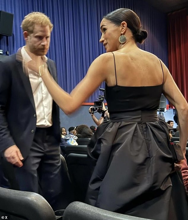 While Meghan (pictured, right) appeared to be in fairly good spirits, her husband Harry (pictured, left) appeared more downcast