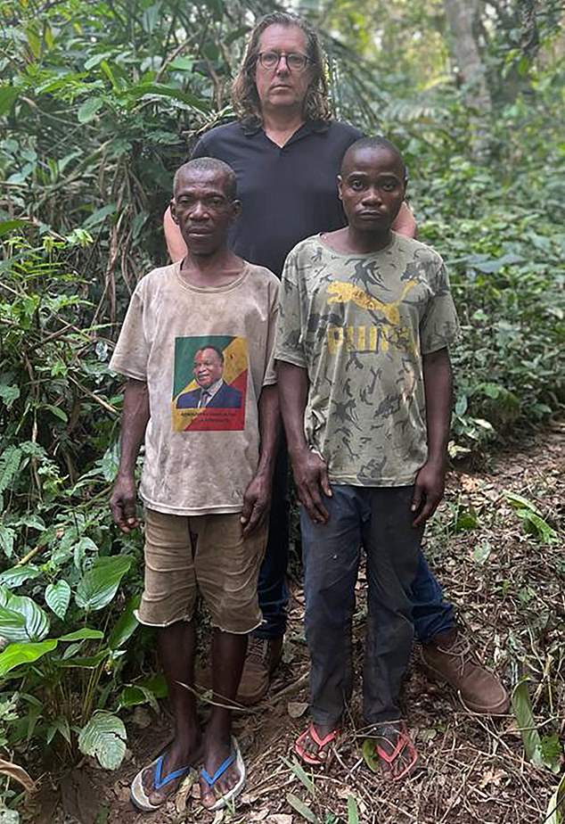 Reporter Ian Birrell with two Baka men who say they were beaten