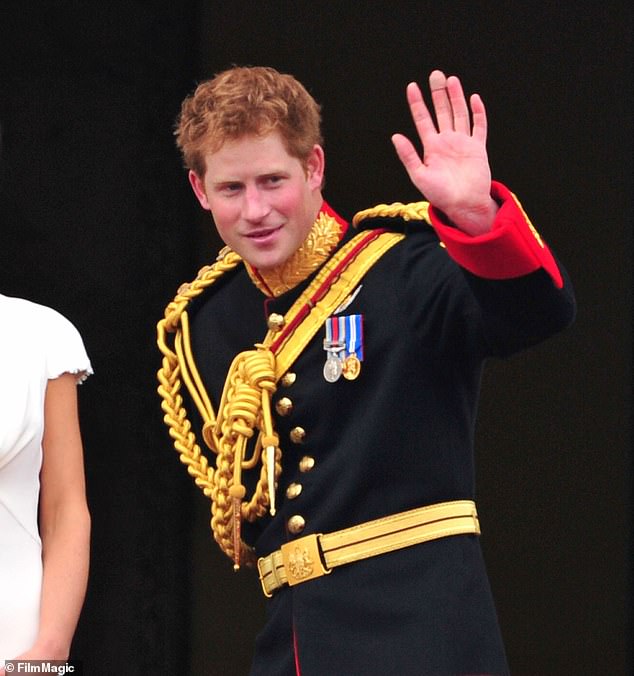 Prince Harry greets crowd of admirers from the balcony of Buckingham Palace in 2011 following the wedding of his brother, William, to Catherine