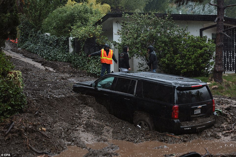 Authorities said rain would taper off in intensity on Tuesday, but the threat of flooding remains high. During a dramatic operation in the early hours of Monday morning, LA firefighters rescued 16 people from nine properties in Studio City - the same neighborhood where George Clooney lives in his $2.2 million luxury pad. The Hollywood star recently transformed the mansion, which he originally bought from Fleetwood Mac singer Stevie Nicks in 1995, from a bachelor pad to a palatial estate fit for his wife Amal Clooney and their five-year-old twins Ella and Alexander. Many residents in the same neighborhood woke up Monday morning to find mud, rocks and debris strewn across the streets, while strong winds have blown bricks onto parked cars and pavements.