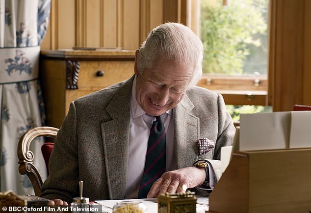 King Charles III smiles at his desk at Balmoral Castle during his Coronation year