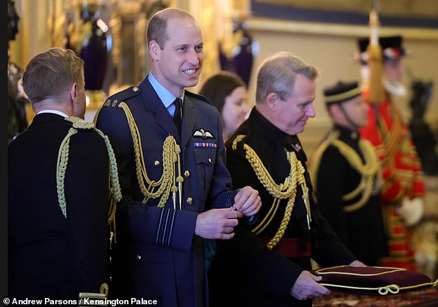 The Prince of Wales smiles as he chats with royal aides prior to today's ceremony