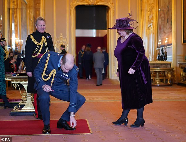 William dropped a medal he was handing to Suzanne Hutchinson, from the charity Little Hearts Matter