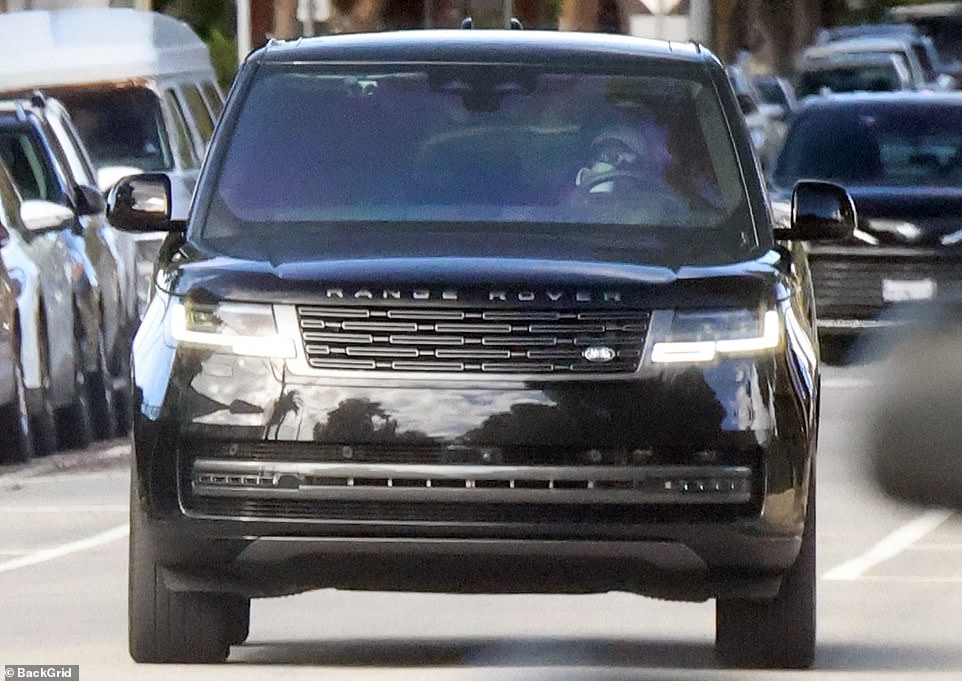 The Duchess kept one hand on the wheel as she sipped from a coffee mug