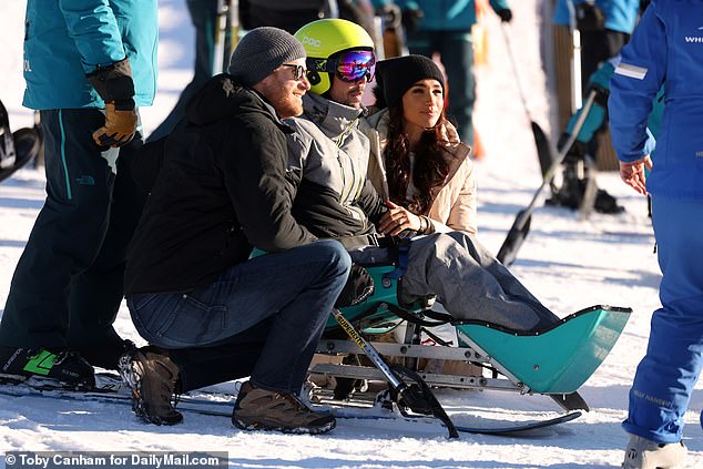 The couple posed for a photo with one of the skiers