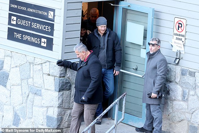 Prince Harry and Meghan leave the training centre after touring the facility