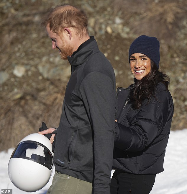 The Duchess clutched onto her husband's arm as she strolled through the resort yesterday