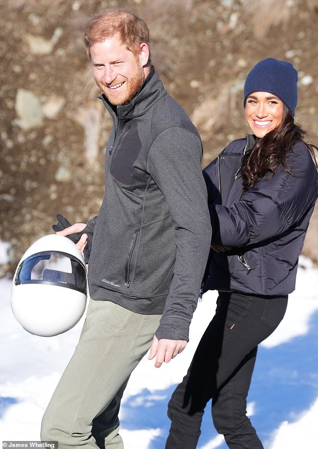 Meghan beamed with pride as her husband recounted his trip around the track