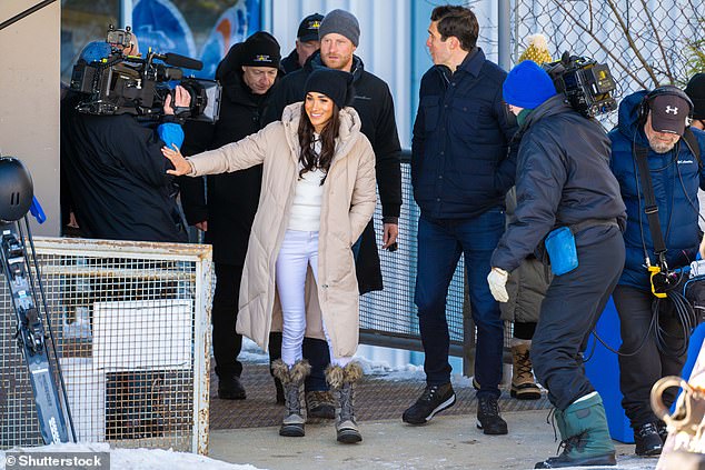 Camers follow Harry, Meghan and Will Reeve at the event in Whistler, Canada, on Wednesday