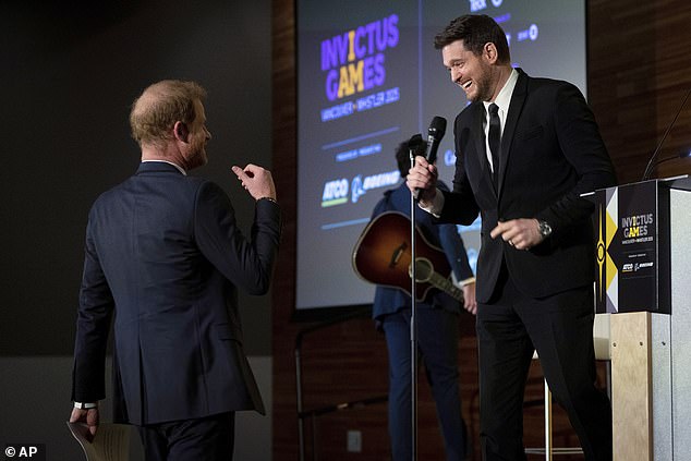 Prince Harry walks to the stage after Michael Bublé's altered version of My Way at an event in Vancouver held to help promote the games