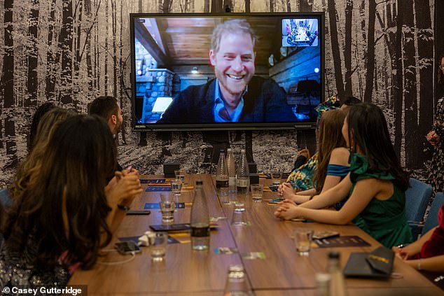 Yusuf then had to wait until it was after midnight before the call with Prince Harry took place. Pictured: Winners sit around a video screen set up in a conference room at the Hilton Hotel near London's Waterloo Station