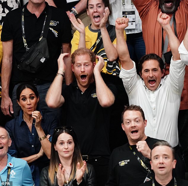 Harry and Johnny cheer during the sitting volleyball final - but the Tory minister denies that any deal over a British bid for Birmingham 2027 was done there, or discussed at all