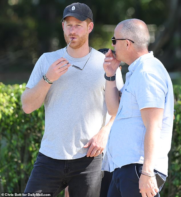 The Prince cut a low-key figure in black jeans and a grey t-shirt - but his arrival was given away by a Netflix film crew who were on hand to shoot his interactions with the awe-struck players