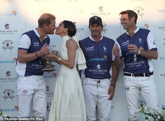 Images showed a delighted - but tired-looking - Harry celebrating with his teammates after the match, applauding his opponents before stepping up to accept his prize from his wife