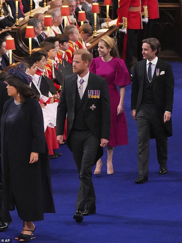 Prince Harry, centre, arrives at Westminster Abbey for the coronation ceremony of Britain's King Charles III. Meghan stayed in the US and he left straight after his father was crowned