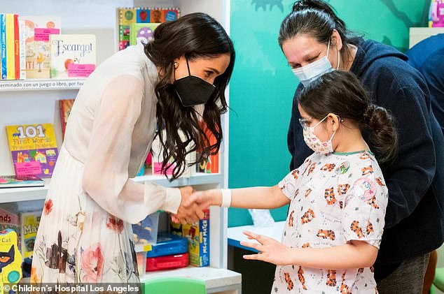 The mother-of-two held onto a Sharpie - ready to autograph the snaps - and leaned down to talk with the children, as well as giving many of them hugs