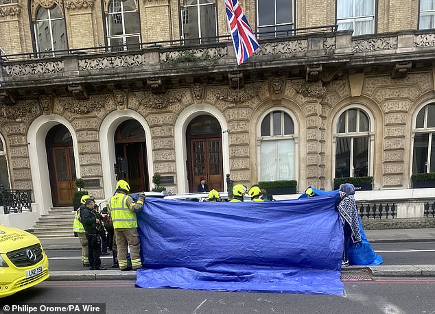 A blue tarpaulin tent was put up around the injured soldier