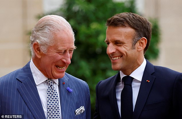 King Charles smiles warmly as he chats to President Emmanuel Macron at the Elysee Palace in Paris on the first day of his state visit