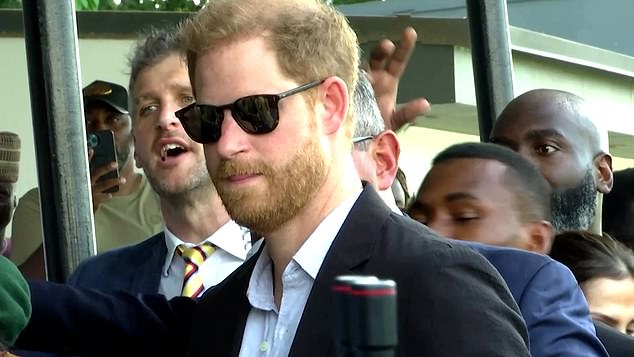 Harry wore black sunglasses and a smart suit for the charity polo match