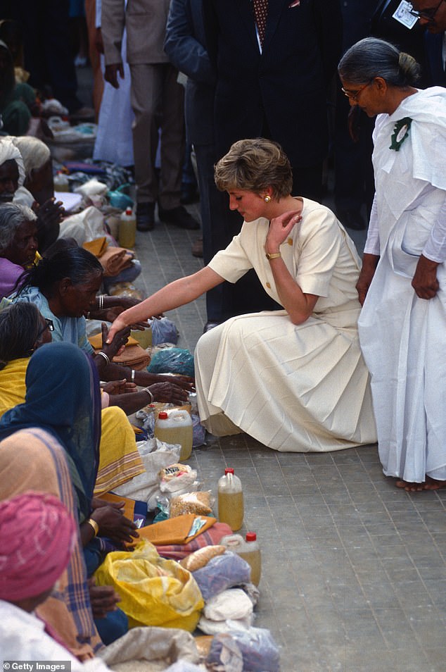 She's got the touch: Diana leans down to shake hands with an 'Untouchable', India's lowest caste, in Hyderabad, India, in 1992