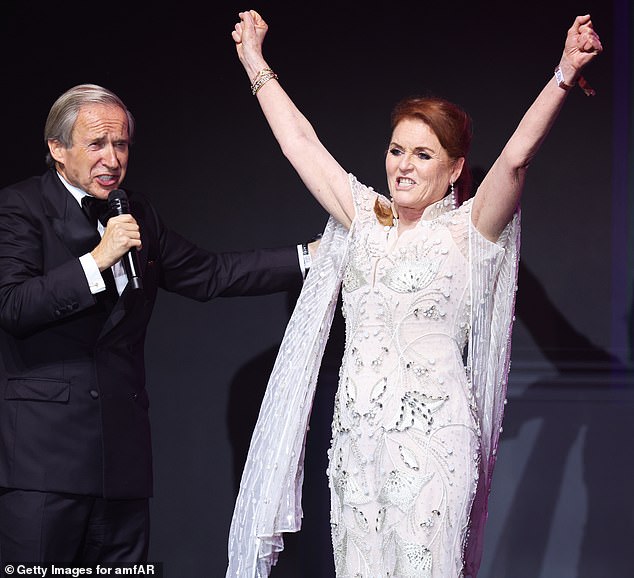 The mother-of-two looked incredible in a Cocktail Dress embellished with striking wispy sleeves and jewels made to look like raindrops