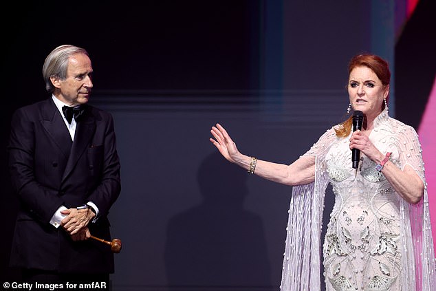 Simon de Pury and Sarah spoke on stage during the amfAR Cannes Gala 30th edition presented by Chopard And Red Sea International Film