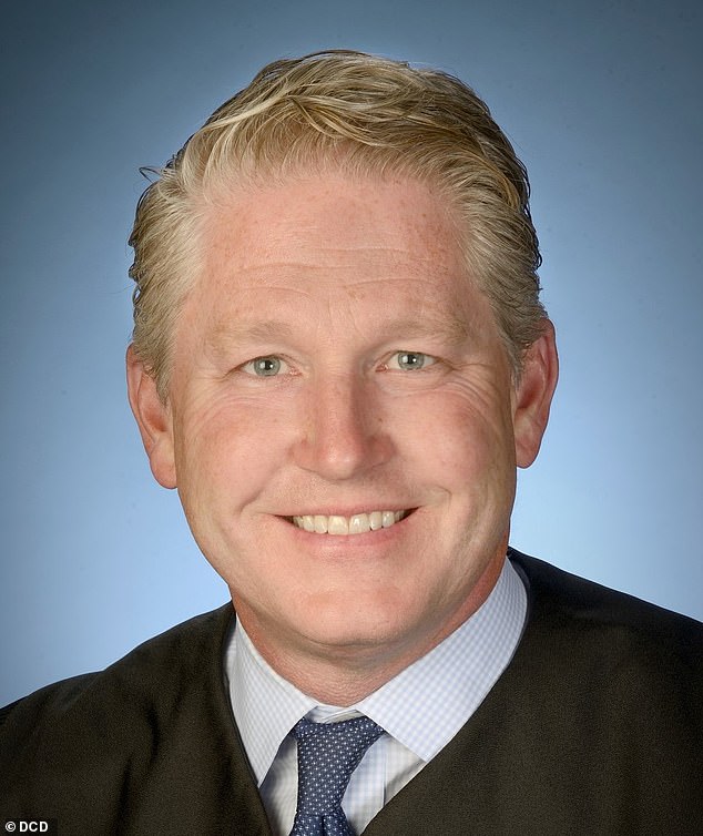 Judge Carl Nichols (pictured) is reviewing the documents in private and is expected to made a judgment 'within weeks' about whether they should be made public