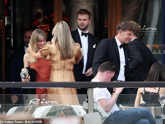 The mother-of-one looked pleased to greet a friend before arriving at the billionaire's wedding island