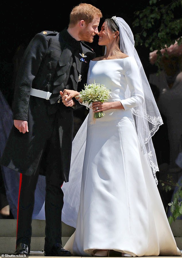 Meghan apparently used Carolyn's dress as one of her inspirations when choosing her dress. Above: With Prince Harry after their wedding ceremony inside Windsor's St George's Chapel