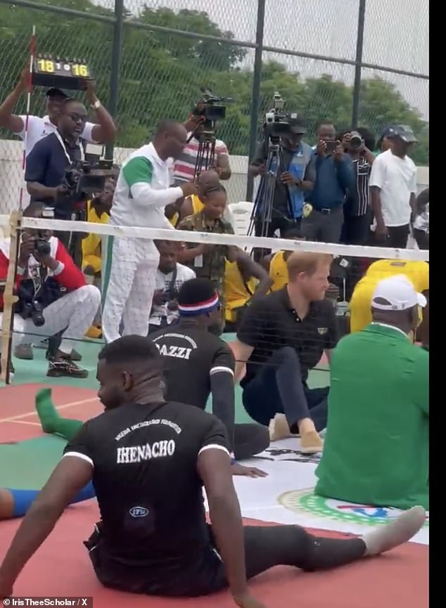 Prince Harry is seen taking part in one of the seated volleyball matches with other players