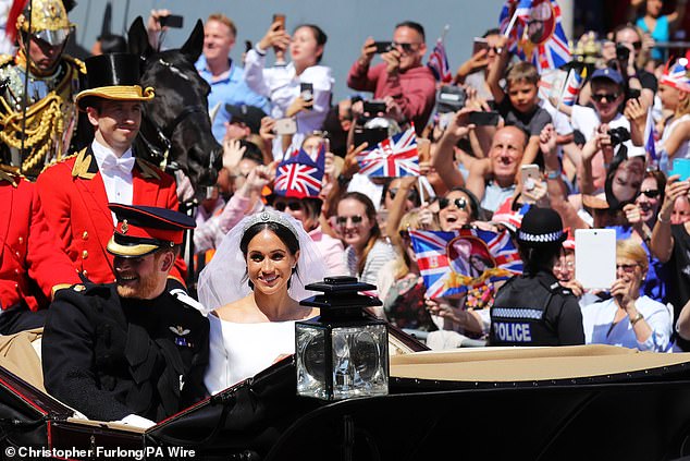 Prince Harry and Meghan Markle ride through Windsor after their wedding ceremony at St. George's Chapel in Windsor Castle