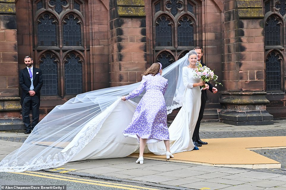 The bride smiled in her wedding dress before walking into the Cathedral to marry the Duke of Westminster