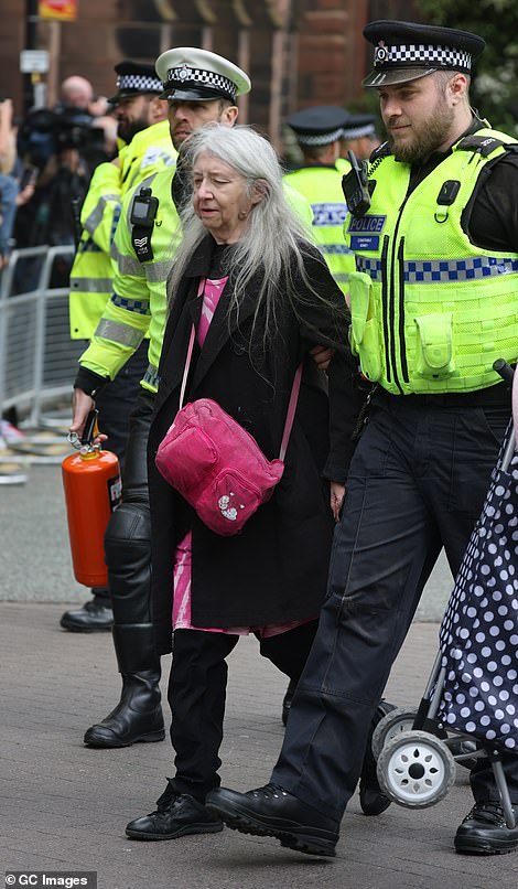 A Just Stop Oil protester is led away by police after trying to disrupt the Duke of Westminster's Wedding