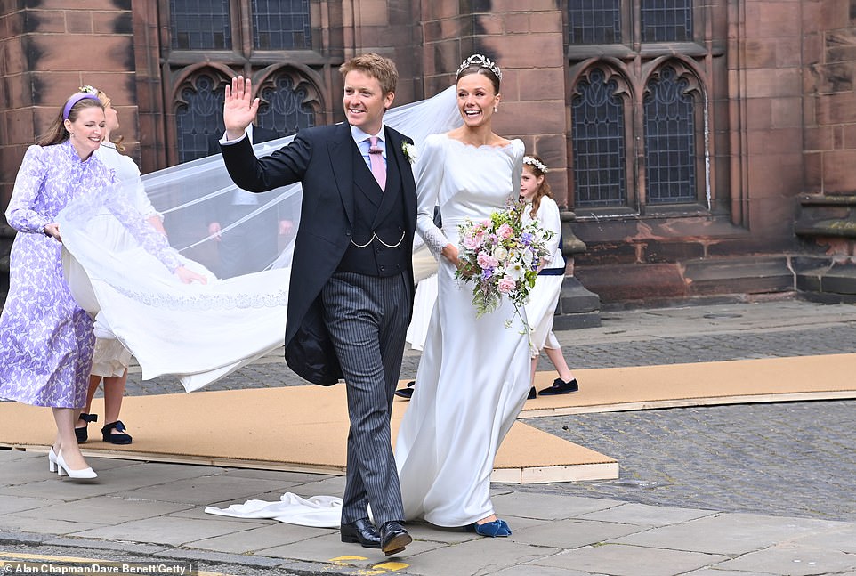 The Duke of Westminster waves at the crowds after tying the knot with Olivia Henson at a lavish ceremony in Chester