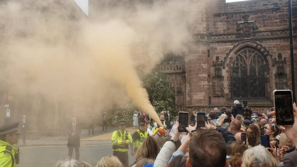 Moments after the ceremony finished, two women let off a fire extinguisher containing the orange powder paint in the direction of the wedding party, which included the Prince of Wales