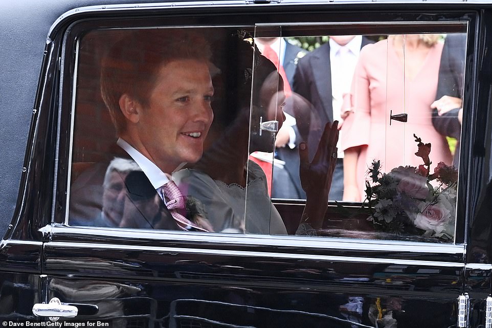 Hugh Grosvenor, 7th Duke of Westminster, smiles as he and Olivia Henson are chauffeured in the Bentley Motors 1930 8-Litre following their wedding at Chester Cathedral