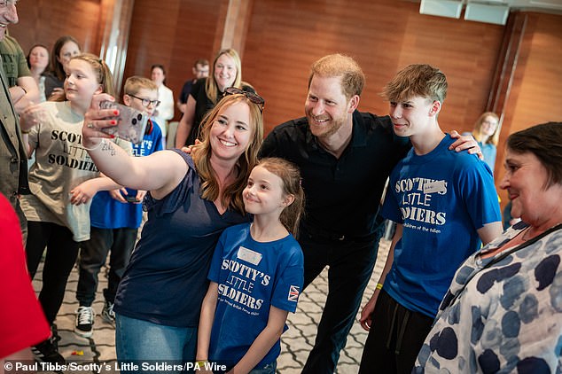 Harry looked in high spirits as he posed for selfies with people from the event