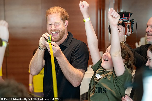 Harry was snapped enjoying games with children and young adults from the charity on an unofficial visit