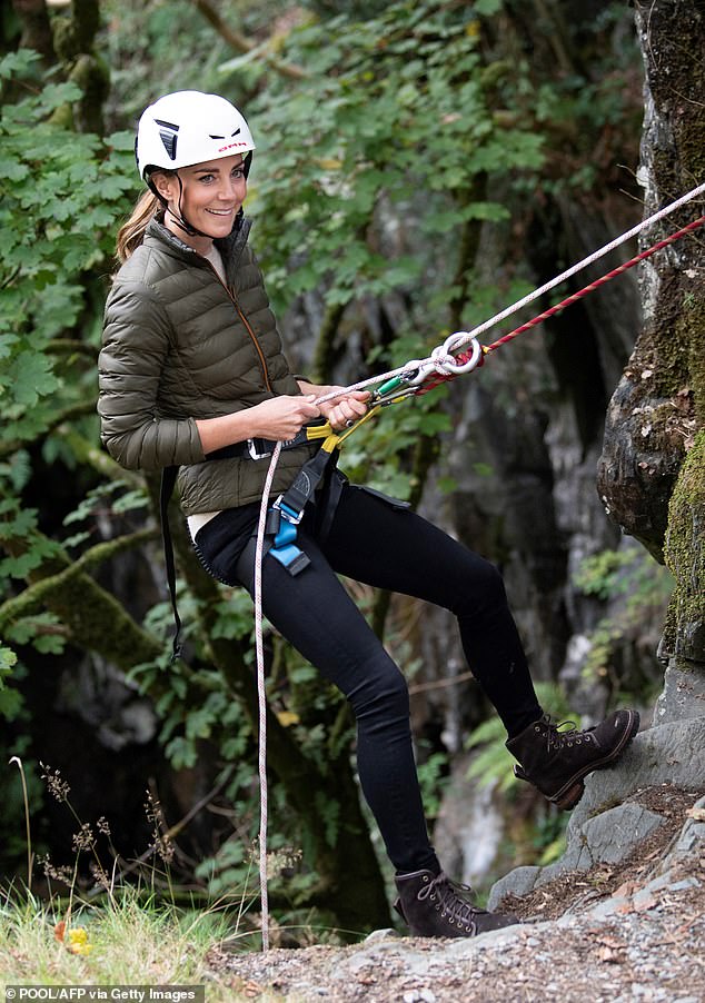 She looked relaxed khaki puffer jacket and white helmet as she chatted to the cadets before easing herself down the rock face at Cathedral Quarry in Little Langdale