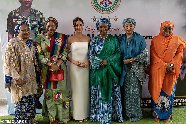 Meghan is pictured stodd next to five other female dinner guests as she attended a lunch with Minister of Defence in Abuja Nigeria