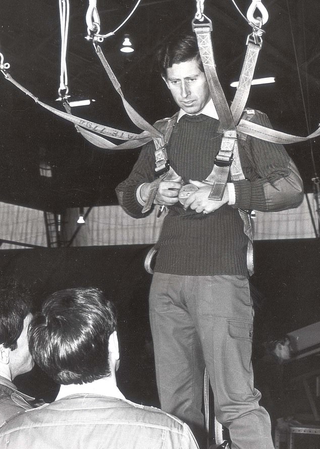 The royal straps himself into a mock parachute in preparation for the jump. Charles had already been made the Colonel-in-Chief of the Parachute Regiment