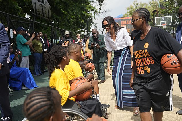 Meghan speaks to the children after their basketball game