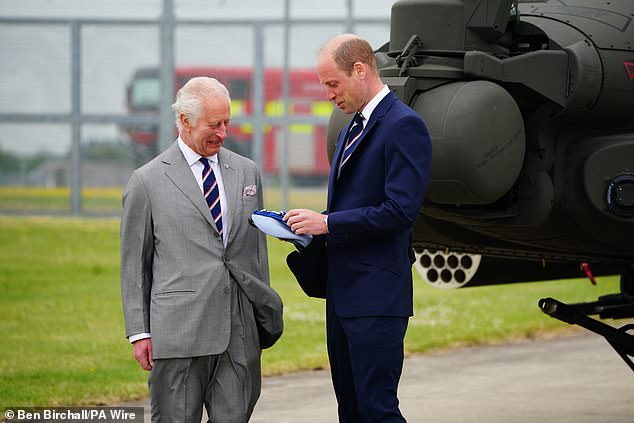 Charles and William smile during the ceremony