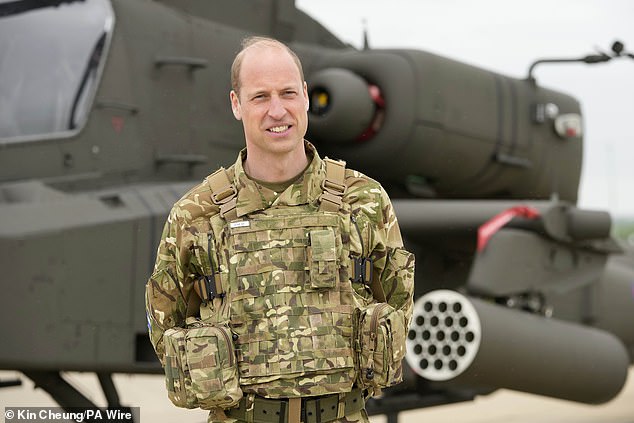 Prince William in front of an Apache helicopter at the Army Aviation Centre today