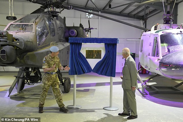 King Charles III unveils a plaque during a visit to Army Aviation Centre at Middle Wallop today